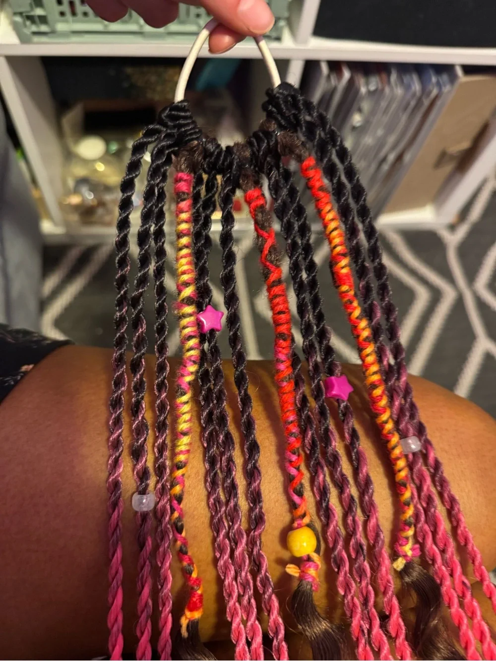Hand-Braided Hair Extensions with Bright Pink Accents